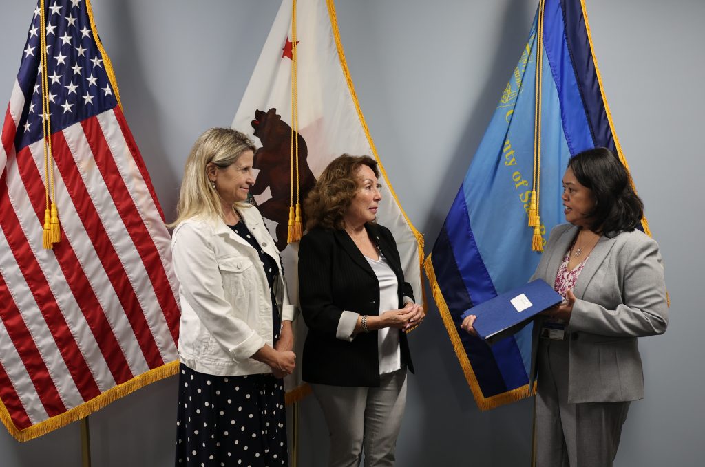 Left to Right: Chair of the Board of Supervisors, Dawn Rowe; Assessor-Recorder_County Clerk Josie Gonzales; and Chief Deputy Auditor-Controller/Tax Collector Franz Zyss. Assessor-Recorder-County Clerk Josie Gonzales presents the 2026 Annual Assessment Roll to Chief Deputy Auditor-Controller/Tax Collector Franz Zyss